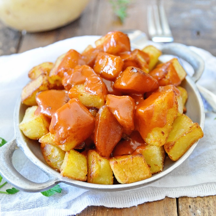 Golden potatoes with red brava sauce